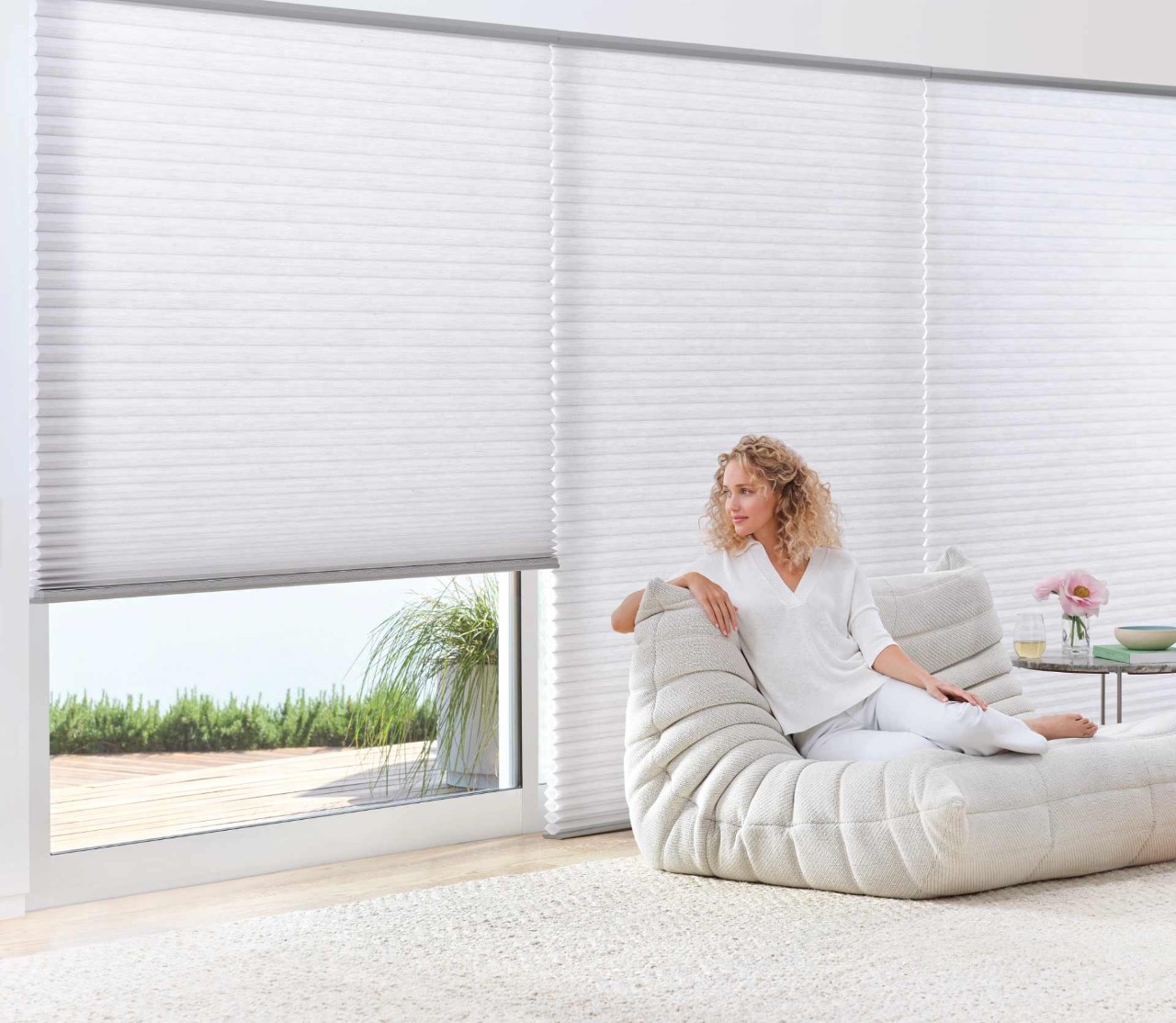 Hunter Douglas Duette® Cellular Shades with a lounging woman near Westford, Massachusetts (MA)